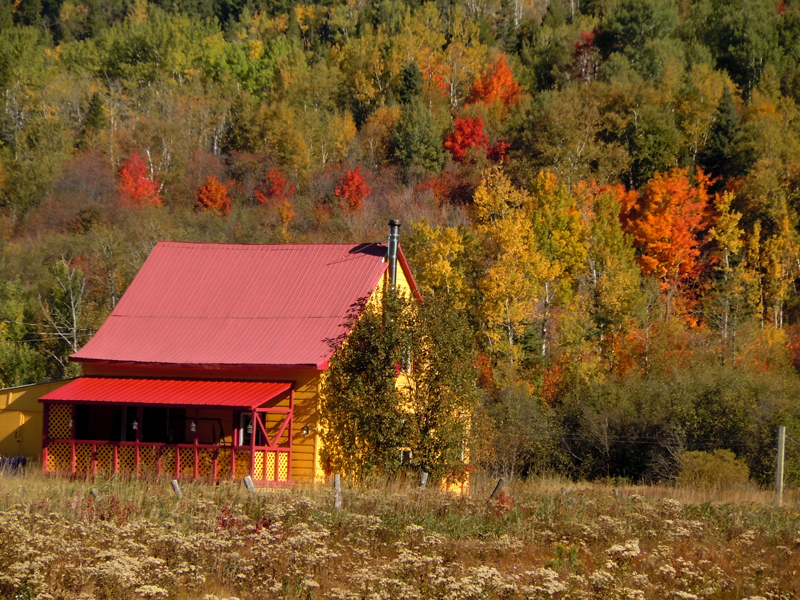 Red and Yellow Wooden House Road 138 near Tadoussac Quebec PQ