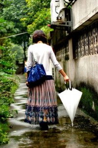 Elder Woman Walking After The Rain